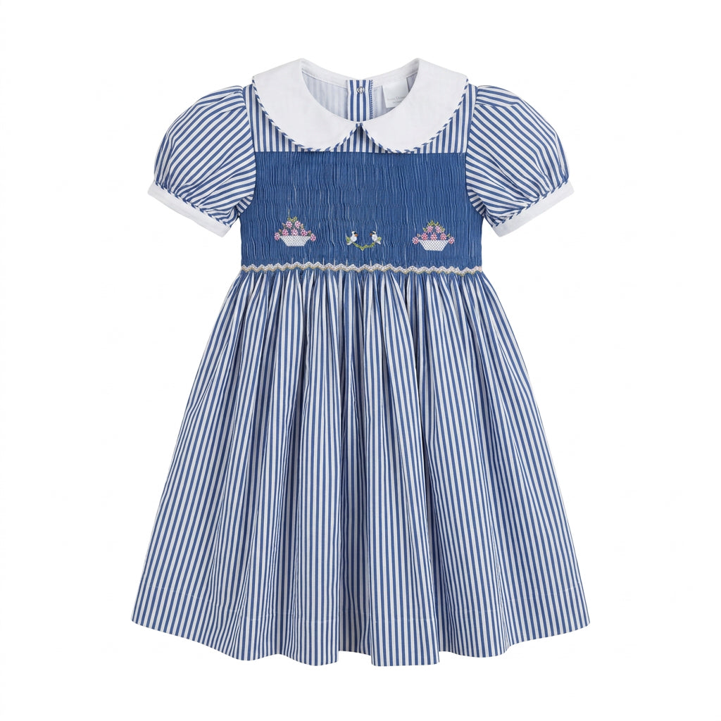 A blue and white vertically striped smocked dress with a white Peter Pan collar, smocked bodice, and embroidered birds and flower baskets.